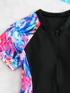 Detail of girls' sports swimsuit collar with colorful print sleeves and front zipper