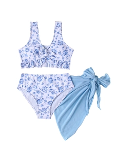 Detailed flat lay of three-piece floral swimsuit with high-waisted bottoms and blue sarong