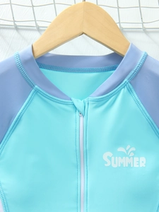 Close-up of children's long-sleeve swimsuit with front zipper and Summer print detail