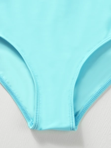 Close-up of double-stitched seams and quick-dry fabric on light blue girls' swimwear
