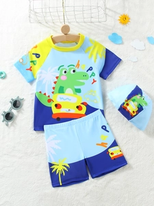 Detailed view of kids dinosaur swimwear with short sleeves, swim trunks and cap