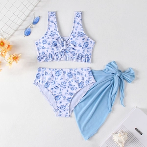 Three-piece girls' floral bikini set with blue mesh skirt and bow tie details