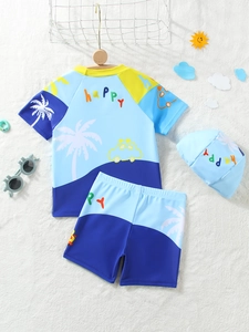 Detailed flat lay of boys three-piece swimwear with dinosaur print and happy text