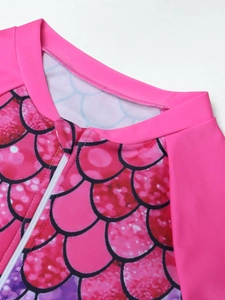 Close-up of girls mermaid swimsuit featuring pink fish scale patterns and front zipper