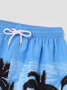 Détail du short de bain bleu pour garçon avec imprimés de cocotiers et taille élastique