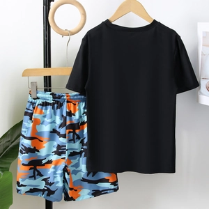 Two-piece boys swimwear featuring a solid black t-shirt and blue camouflage swim trunks