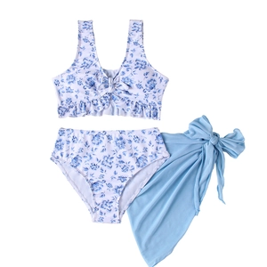 Three-piece floral bikini set with ruffles and a matching light blue mesh beach sarong skirt