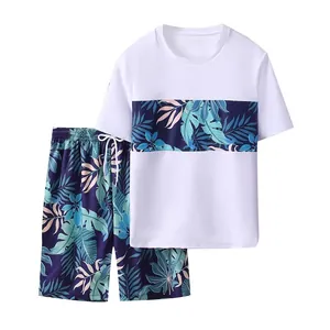 Two-piece boys swim set featuring white t-shirt and tropical leaf print beach shorts