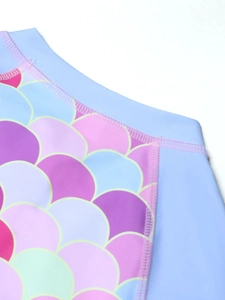 Detail of mermaid scale pattern and flatlock stitching on kids long sleeve swimwear