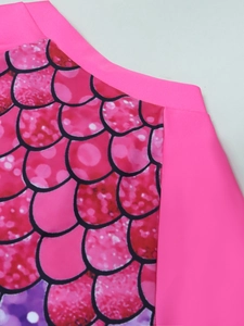 Close-up of pink fish scale pattern on quick-dry fabric for kids' swimwear