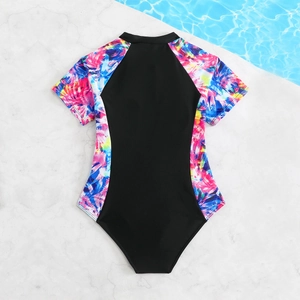 Girls one-piece short sleeve rash guard swimsuit with black panels and tropical floral print