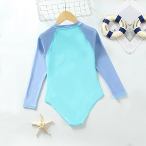 Long-sleeved one-piece girls' swimsuit in light blue and lilac with beach accessories