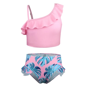 Two-piece girls swimsuit featuring pink ruffled shoulder top and tropical leaf print bottoms