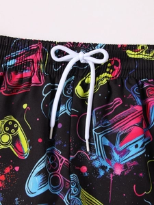 Detail of boys beach shorts featuring retro neon game console prints and elastic drawstring
