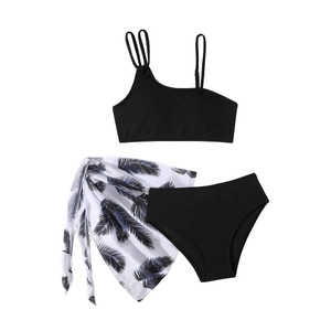 Three-piece girls black bikini set with palm leaf sarong and ribbed fabric texture