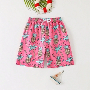 Pink kids swim shorts with tropical pineapple and palm tree prints for beach summer wear