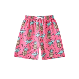 Kids pink quick dry swim shorts with pineapple and palm tree prints for summer beach