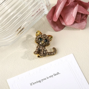 Elegant gold cat brooch with sparkling brown rhinestones and green crystal eyes