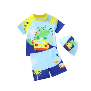 Three-piece boy swimming suit with short sleeves and dinosaur print on blue and yellow