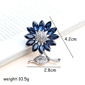 Blue sunflower brooch in silver alloy with crystals on an English book, 4.2x2.8cm