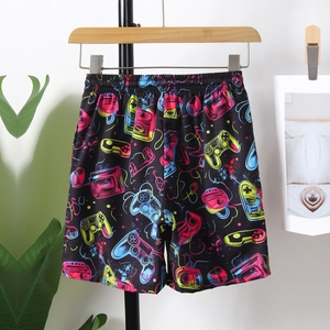 Boys quick dry beach shorts featuring neon gaming controllers and vibrant retro prints