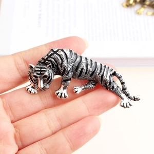 Macro shot of vintage silver cheetah brooch with black enamel details and lifelike texture