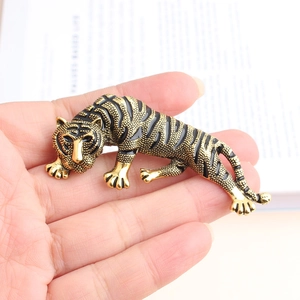 Detailed macro view of a vintage leopard brooch in golden alloy with black enamel finish