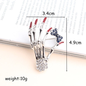 Gothic skull hand brooch with rhinestones and red fingertips, size 3.4cm by 4.9cm