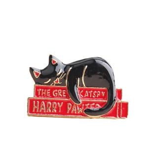 Creative black cat on red books enamel pin featuring literary pun designs for clothing