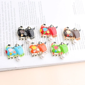 Set of six colorful enamel cow brooches with dangling pearls and heart patterns