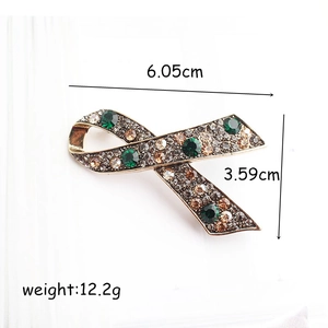 Vintage ribbon brooch with green crystals and rhinestones, size 6.05cm by 3.59cm