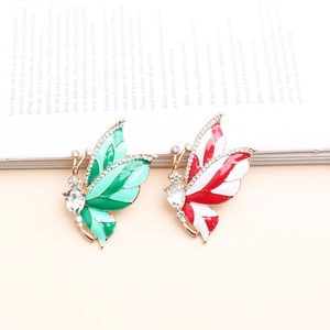 Close-up of enamel butterfly brooches with rhinestones on an open vintage book