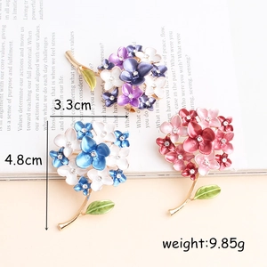 Elegant flower brooches with rhinestones and enamel finish in three vibrant colors