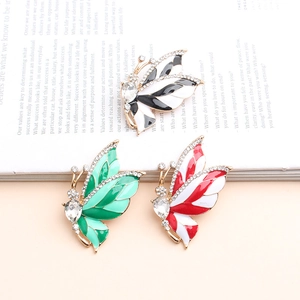 Detailed close-up of a butterfly brooch set featuring rhinestones and colorful enamel art