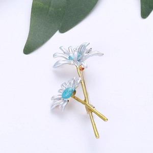 Detailed close-up of handmade blue enamel daisy brooch with gold-tone stem and leaves