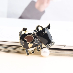 Cute enamel cow brooch with gold outlines and hanging white pearl detail