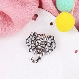 Detail of vintage silver elephant brooch featuring crystal rhinestones and artistic patterns