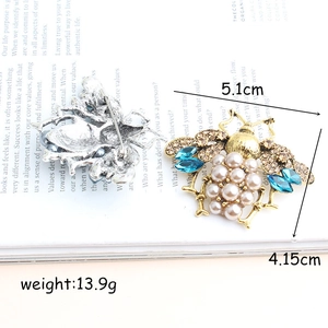 Vintage bee brooch with blue crystal wings and faux pearl body shown from both sides