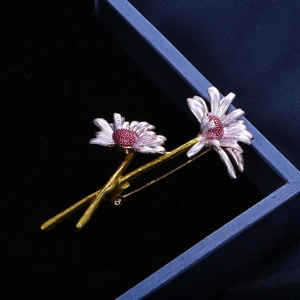 Detailed macro shot of handmade purple enamel daisy brooch with sparkling red rhinestones