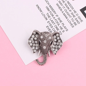 Vintage elephant brooch with sparkling crystals and silver-tone metal texture