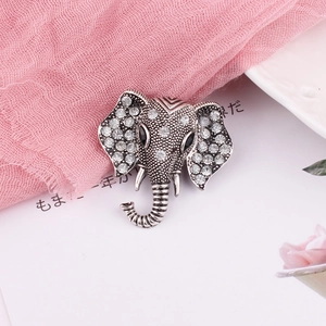 Detailed close-up of elephant brooch with silver plating and crystal rhinestones