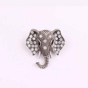 Sparkling elephant head brooch with clear rhinestones and black gem eyes in vintage silver