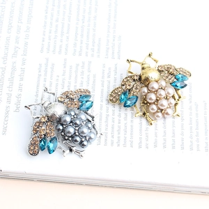 Fashion bee brooches with crystal wings and pearls in gold and silver finishes