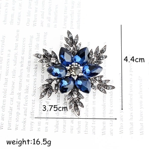 Elegant snowflake brooch with blue rhinestones and silver alloy leaves measuring 4.4cm by 3.75cm
