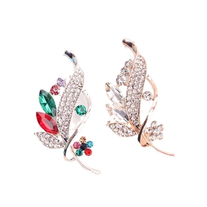 Elegant gold leaf brooches with vibrant colorful crystals and clear white rhinestones