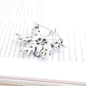 Vintage silver star brooch with blue stone inlay on an open book background