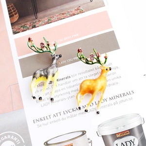 Cartoon alloy reindeer brooches with enamel finish and red rhinestones on art magazine
