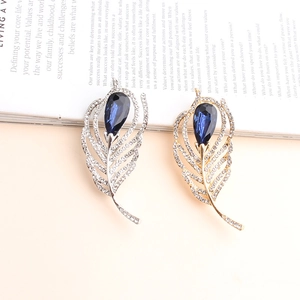 Sparkling crystal flower brooches with blue teardrop stones in gold and silver finish