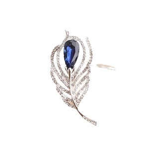 Elegant silver feather brooch with a deep blue crystal pear and shimmering white rhinestones