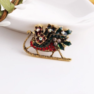 Spilla a forma di slitta di Natale dorata con pacchi regalo rossi e strass colorati brillanti